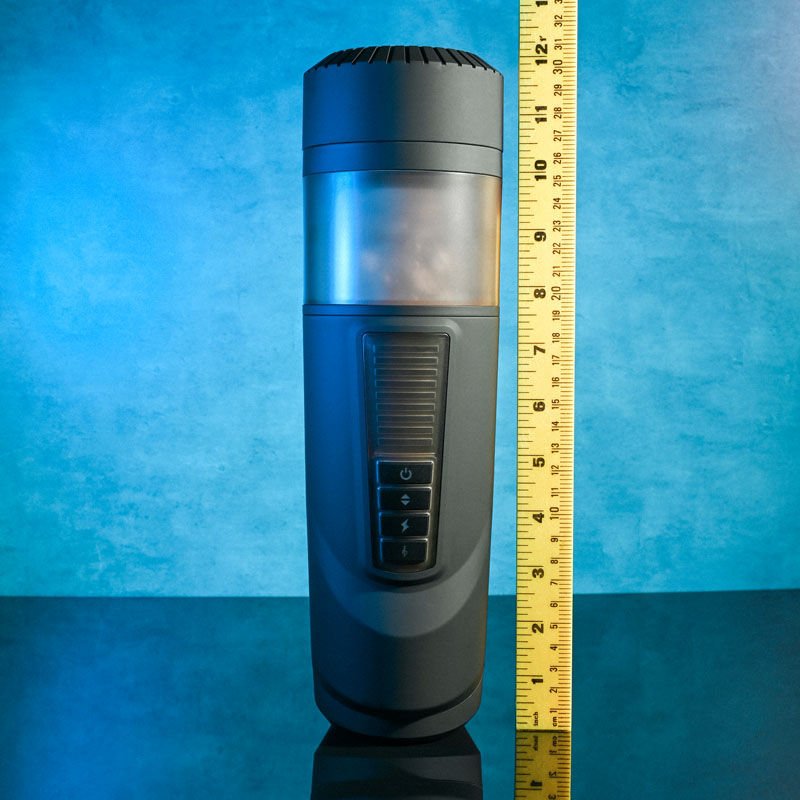 Front view of the Gender X Message in a Bottle Stroker Male Masturbator next to a ruler for size reference, set on a blue decorative background. | Flirty Bay adult store Perth